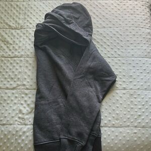 Dark grey ribbed half zip hoodie, it is cropped and has thumb holes